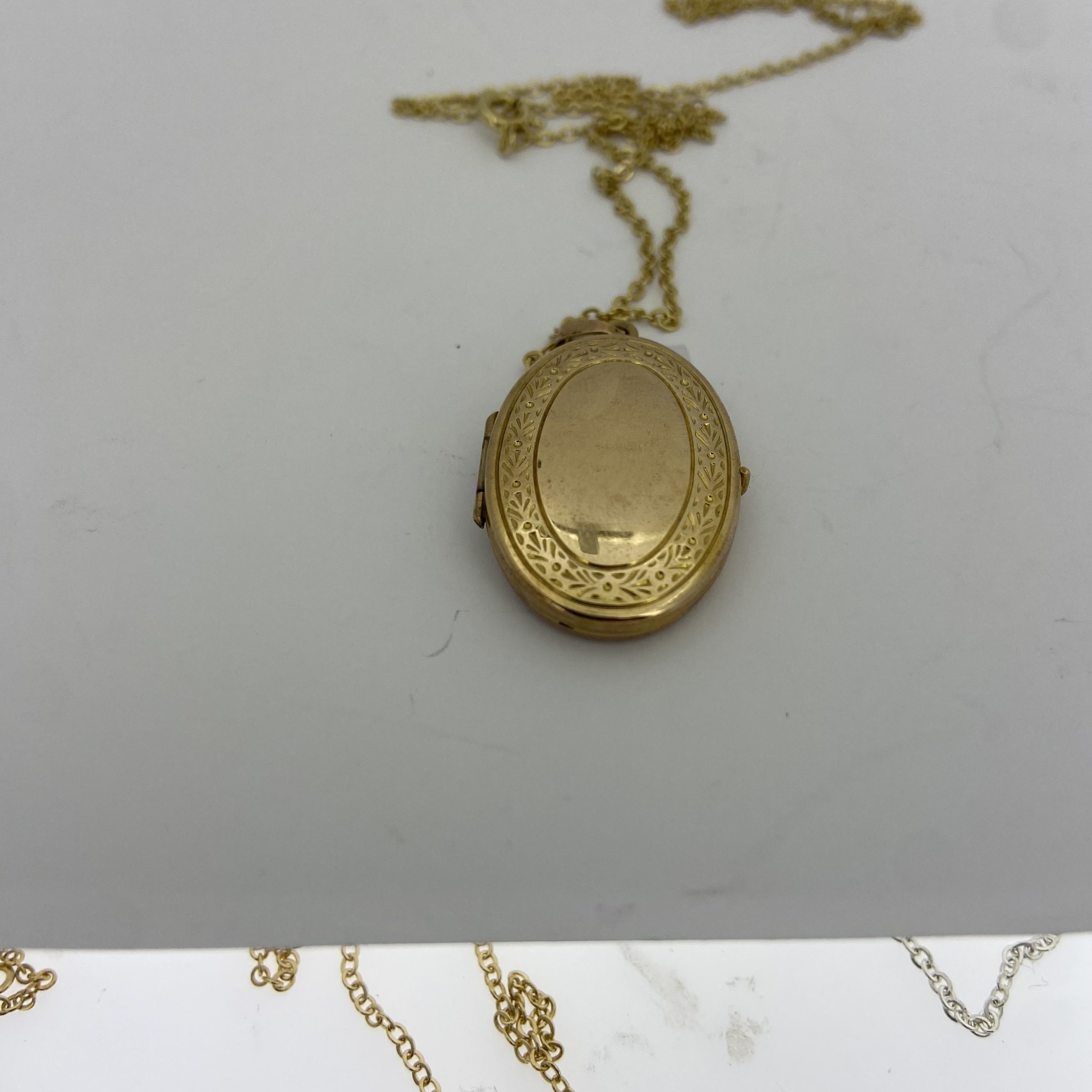 Gold oval store locket